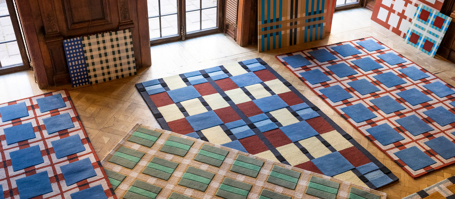 Layered Evelina Kroon Ochre Fields wool rug